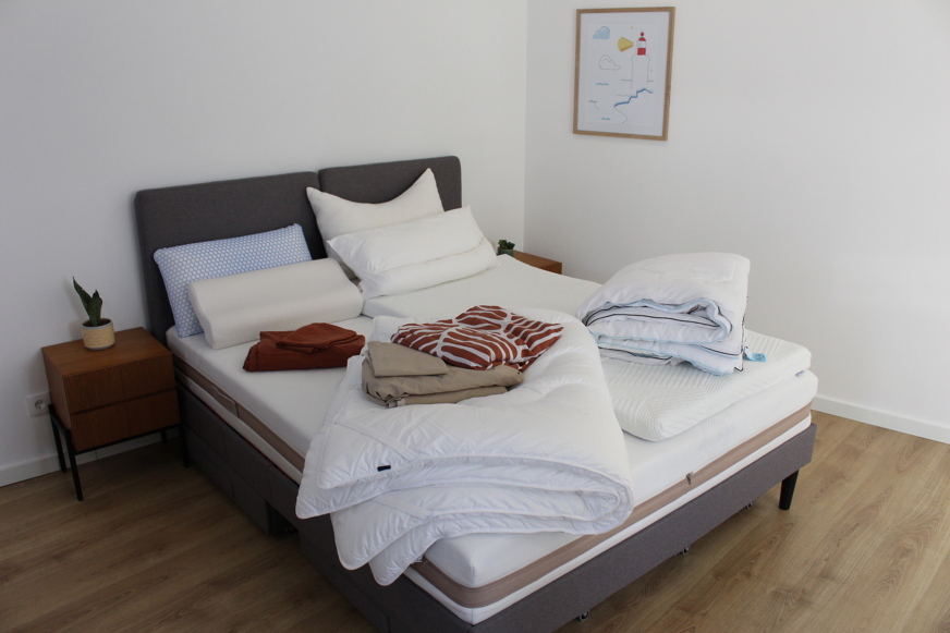 multiple sleep products on bed